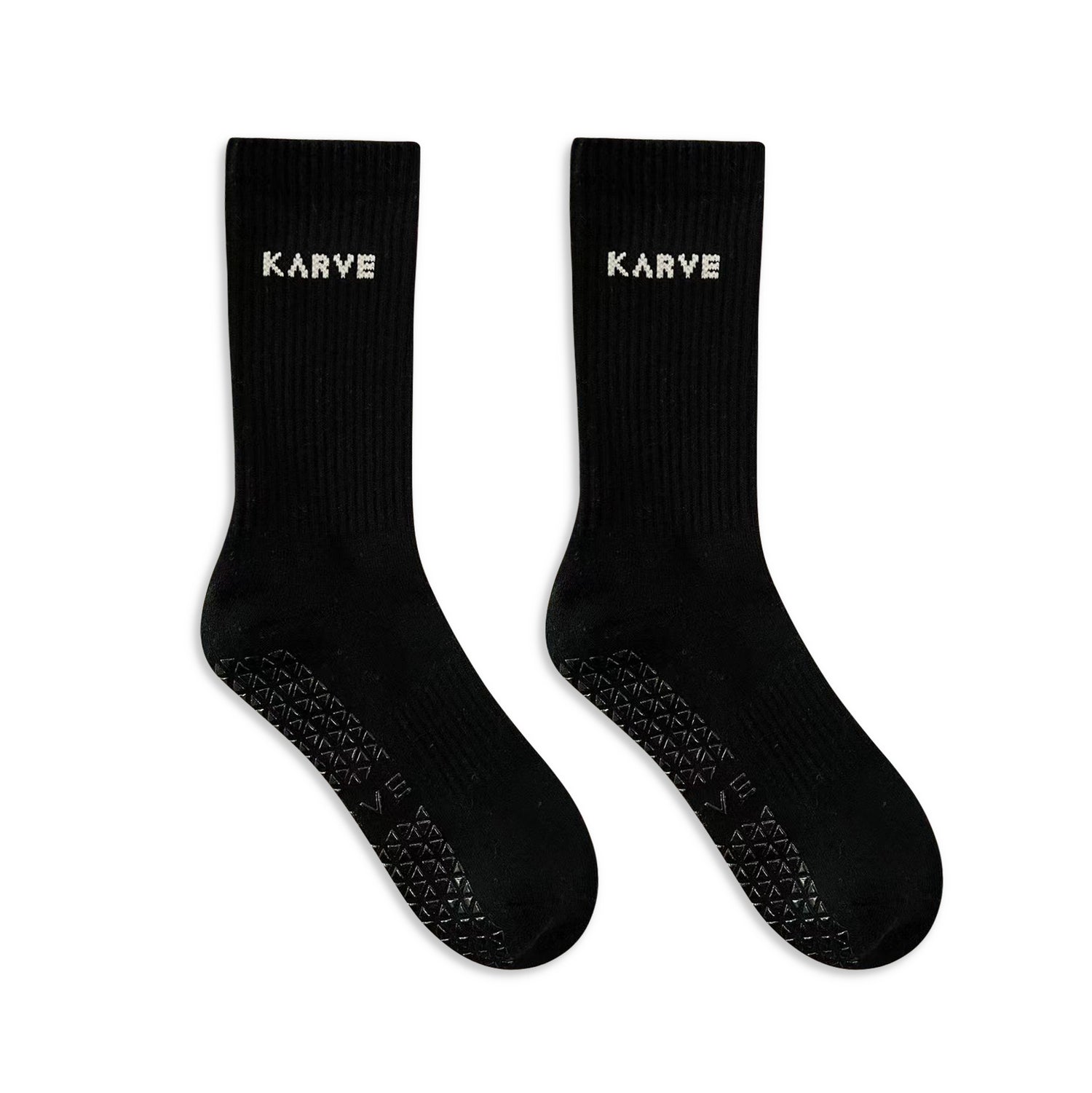 A pair of black long grip socks with non-slip silicone grips and the brand name 'KARVE' printed on the ankle area.